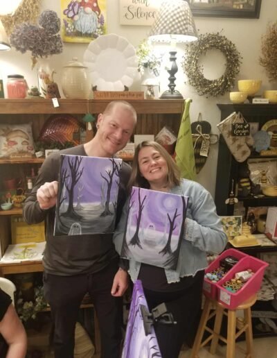 ghost of the forest art class Kyle and Sarah with their finished paintings